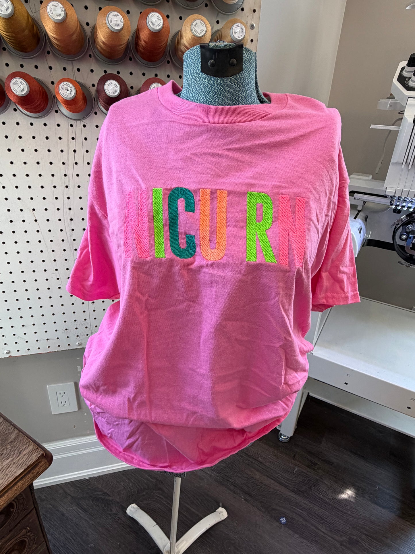 Large bright pink NICU RN